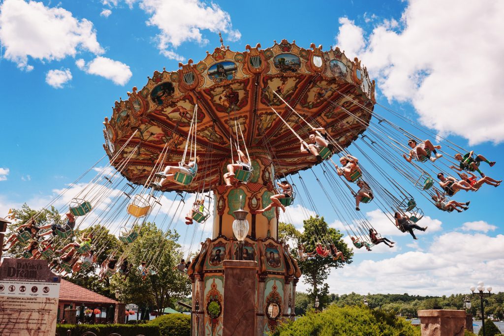 A carnival ride where people ride in seated swings and the ride swirls around and around.
