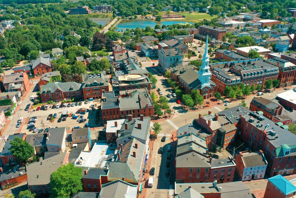 An aerial view over Portsmouth's Market Square, with lots of red brick buildings and a church with a white steeple.