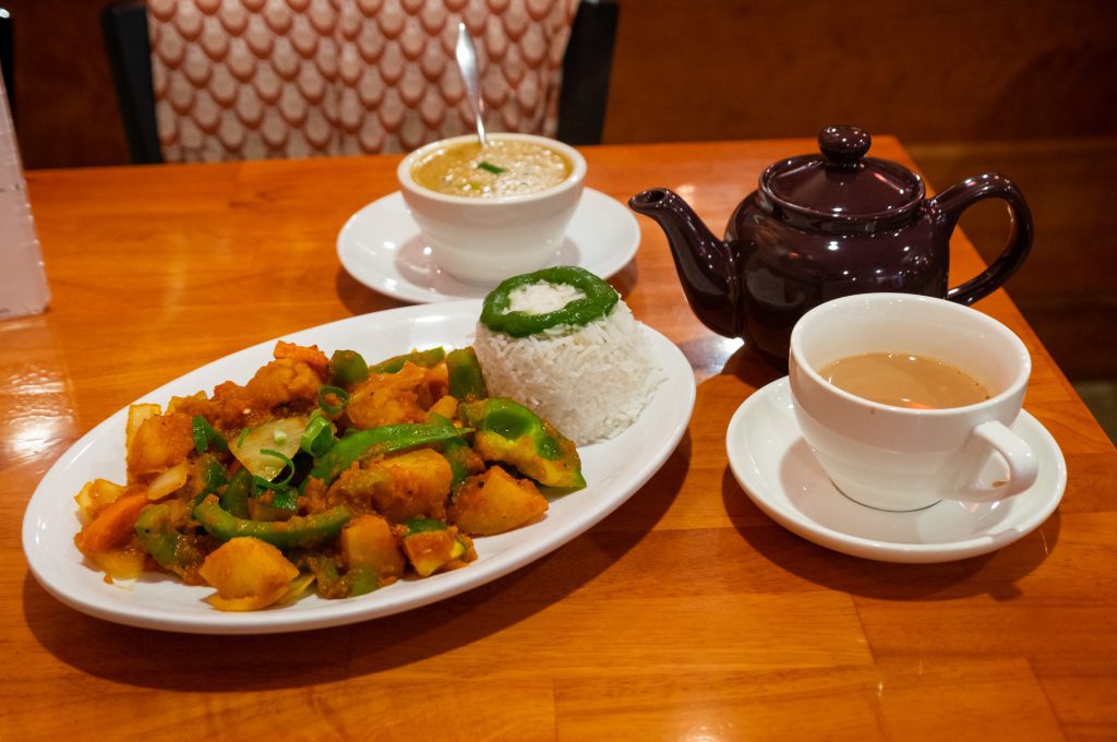 A Nepalese curry, a Dahl soup, and a teapot and cup of chai.