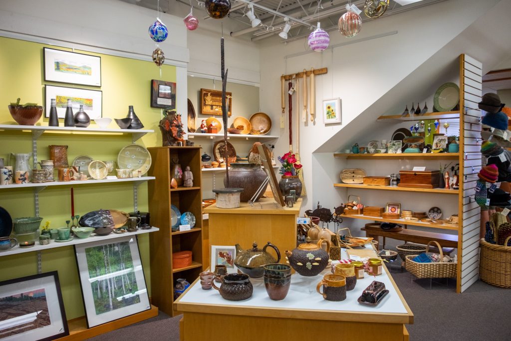 A gift shop filled with artistic home wares, like teapots, vases, platters, and boxes.