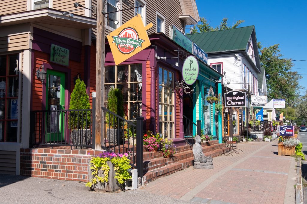 A row of colorful shops on a small street in North Conway.