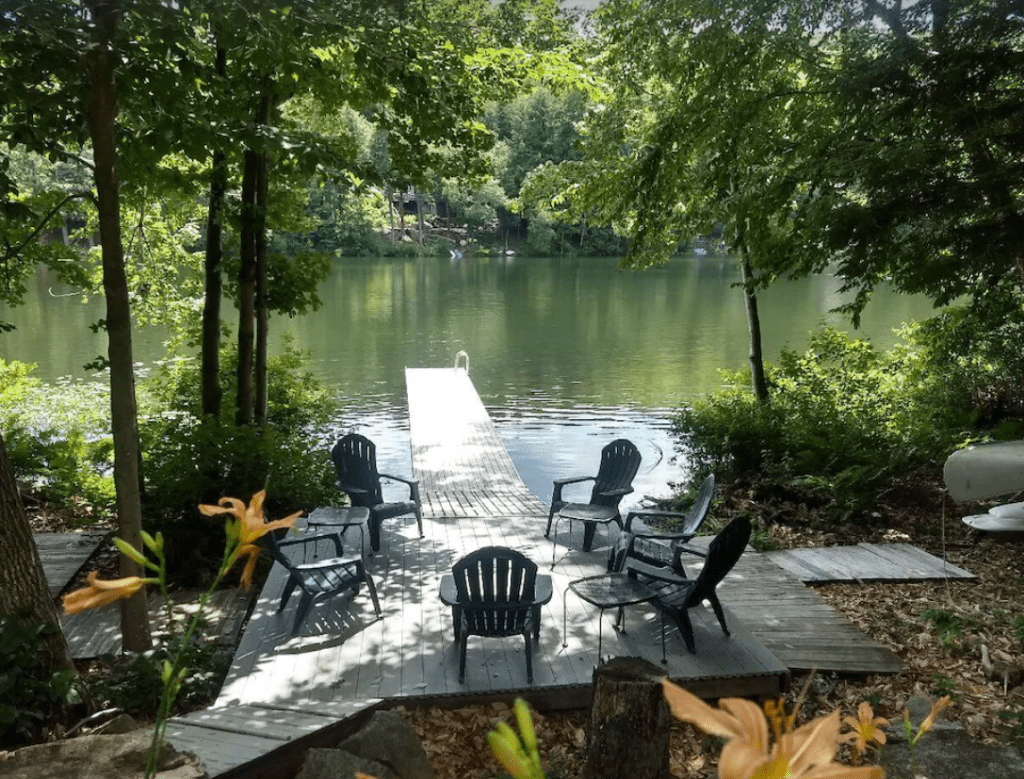 A private dock and deck with chairs over Chalk Pond