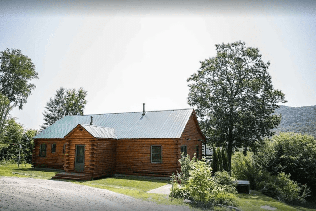 A log home with trees behind it