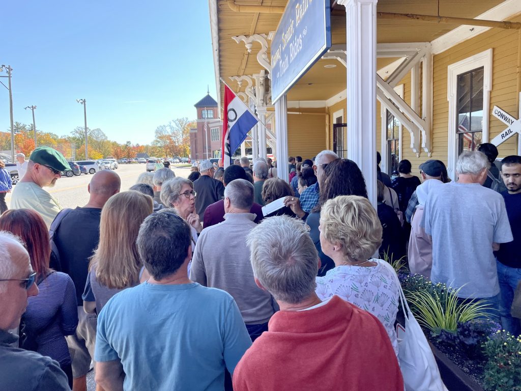A huge crowd of people waiting to board a train.
