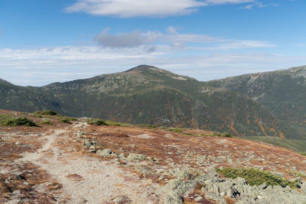 A hiking path leading to mountains in the distance.