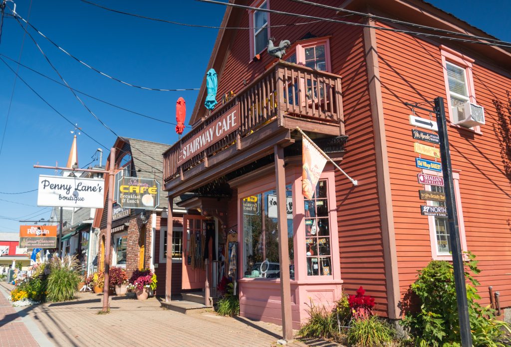 A row of red painted shops in small town North Conway.