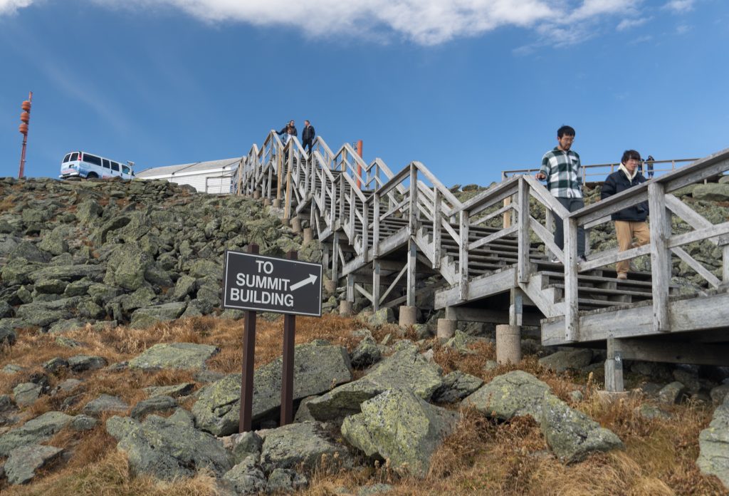 A wooden staircase leading up a Rocky Mountain face.